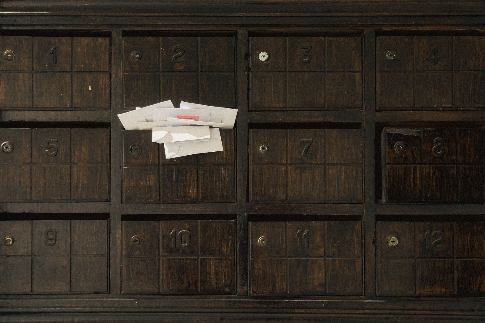 An envelope pushed through the letterbox of a front door