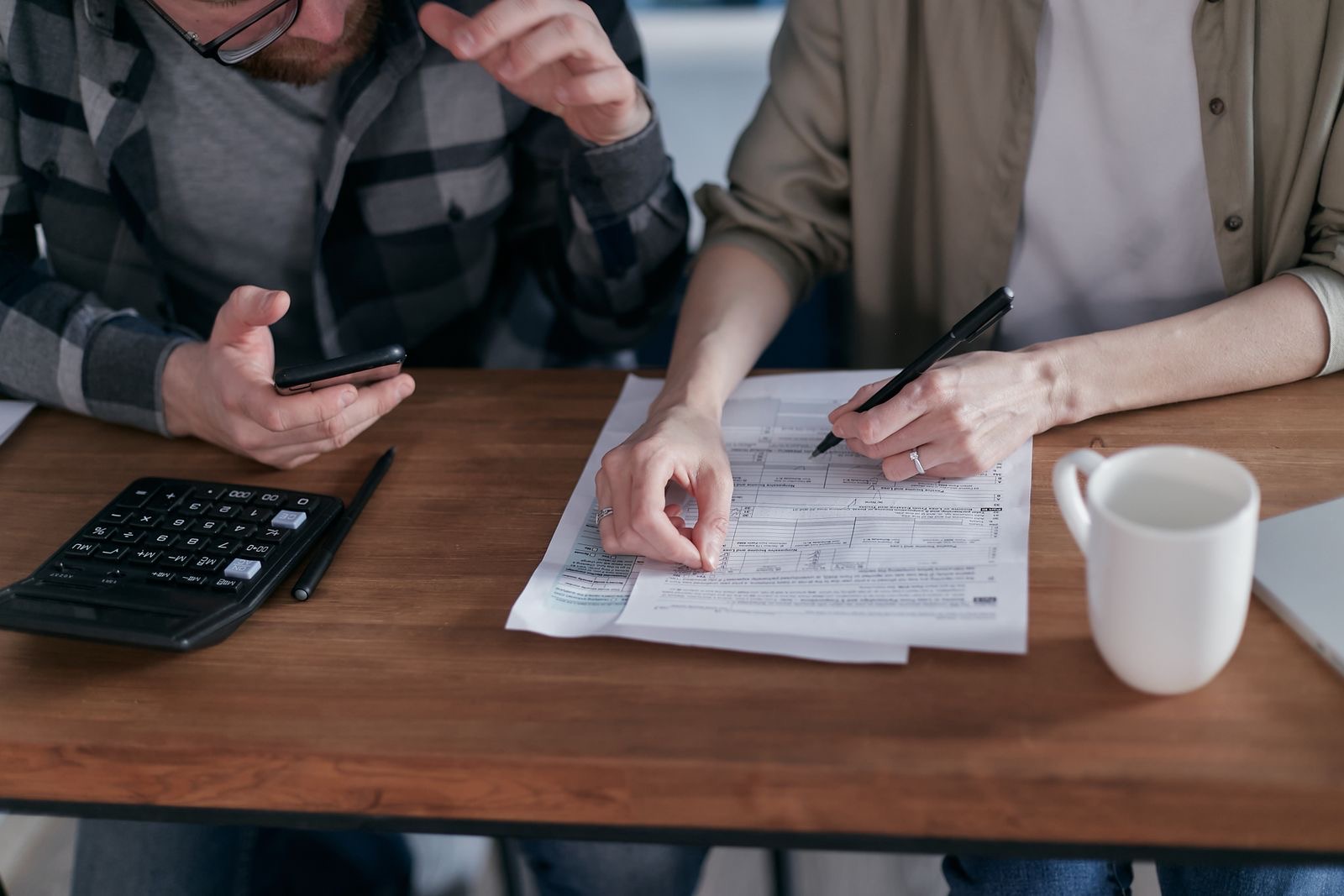 Shipping documents and an invoice on a desk being checked before an import declaration.