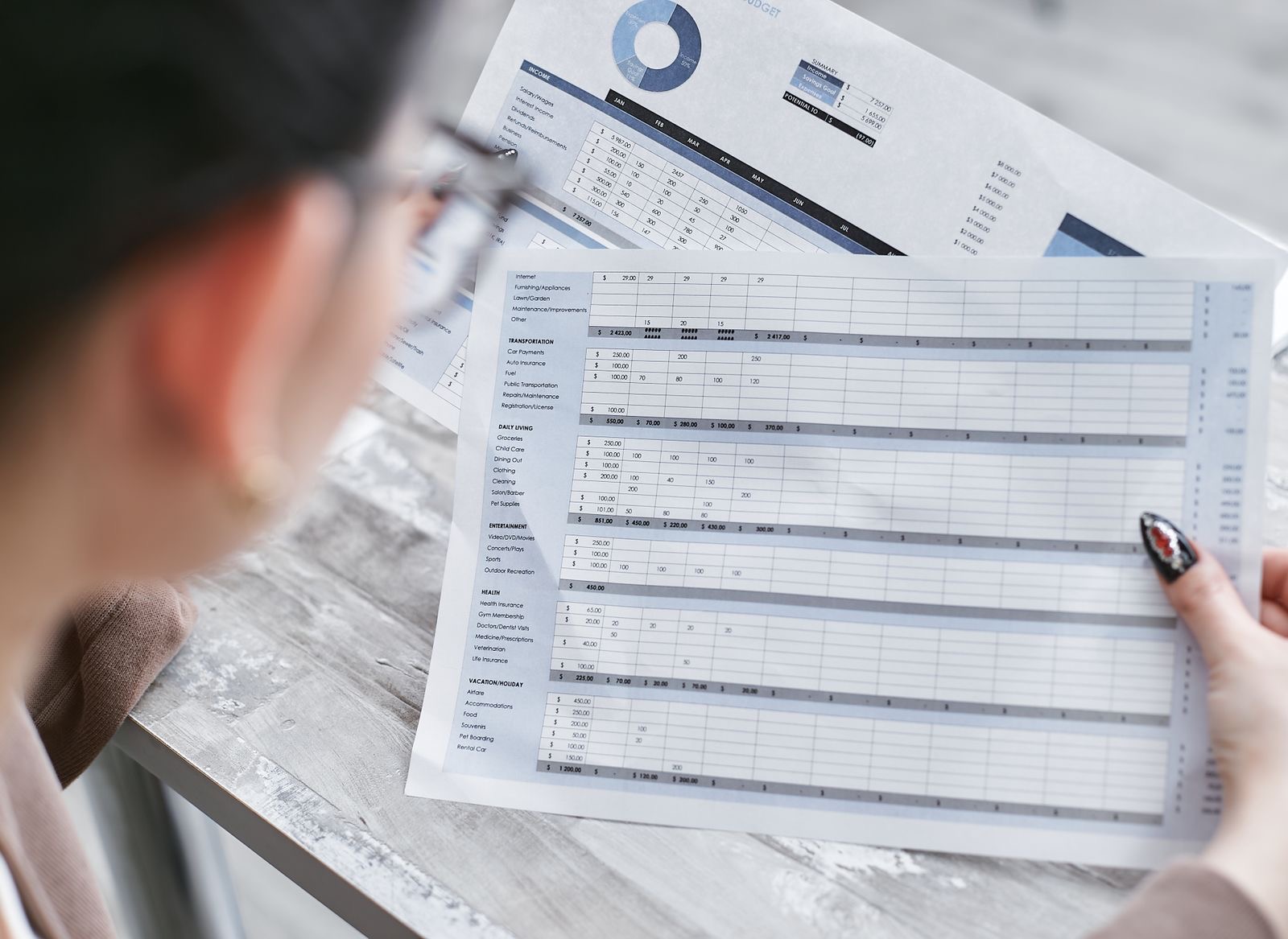 A consultant and a founder reviewing a business plan and financial forecast at a desk.