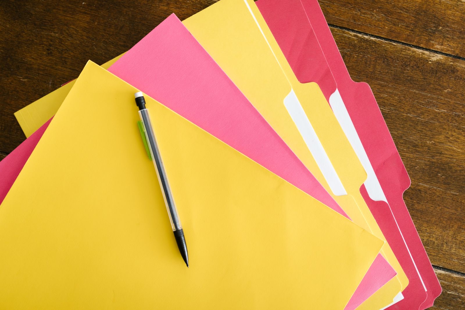 Invoices, a ledger and a passport on a desk, the pack a BV hands over before its tax filings.